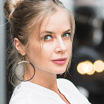 Circular headshot photo of a woman with hoop earrings