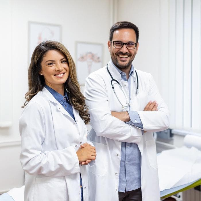 Photo of two smiling doctors in white coats